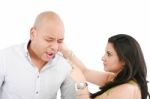 Lady Twisting Her Husband Ear Stock Photo