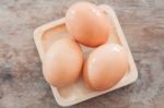 Fresh Eggs On Wooden Plate Stock Photo