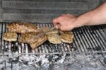 Turning Steaks And Ribs On Bbq Stock Photo