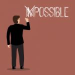 Businessman Changing The Word Impossible Into Possible Stock Photo