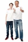 Smiling Father And Son Showing Thumps Up Stock Photo