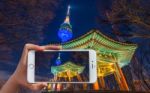 Hand Holding Smart Phone Take A Photo At Seoul Tower At Night Stock Photo