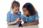 Schoolgirls Learning With Microscope Stock Photo