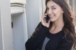 Young Woman Holding A Tablet On The Street Stock Photo