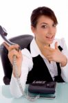 Front View Of Happy Businesswoman Pointing At Phone Stock Photo