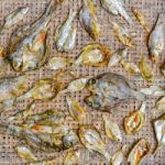 Small Dry Fish From The Sun On The Net Stock Photo