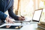 Business Man Working At Office With Laptop, Tablet And Graph Dat Stock Photo