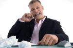 Frustrated Businessman Biting Pen Stock Photo