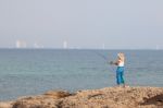 Girl Fishing On Beach Stock Photo