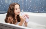 Little Girl Washing Her Hair With Shampoo Stock Photo