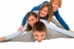 Smiling Teenagers Laying On Floor Stock Photo