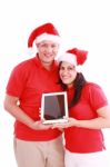 Couple With Touchpad On Christmas Stock Photo