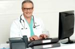 Senior Doctor Using Computer Stock Photo