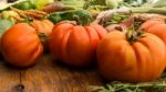 Several Vegetables On Wooden Chopping Board And Table Stock Photo