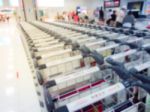 Blurry Of Luggage Trolley  And Passenger In The Airport Hall Stock Photo