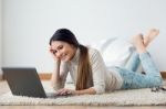 Beautiful Young Woman Working On Her Laptop At Home Stock Photo