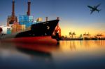 Container Ship In Import,export Port Against Beautiful Morning Light Of Loading Ship Yard Use For Freight And Cargo Shipping Vessel Transport Stock Photo