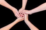 Five Teenage Arms With Hands Entangled Isolated On Black Backgro Stock Photo