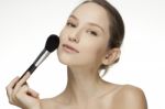 Woman Applying Make Up With Brush Stock Photo