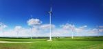 Wind Turbines In Front Of Blue Sky Stock Photo