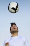 Football Player Striking The Ball At The Stadium Stock Photo