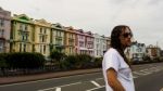 Man Standing In Front Of A Row Of Houses Stock Photo