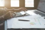 Businessman Working With Calculator, Business Document And Lapto Stock Photo