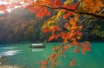 Boatman Punting The Boat At River. Arashiyama In Autumn Season Along The River In Kyoto, Japan Stock Photo