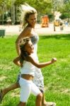 Mother Running With Her Daughter Stock Photo