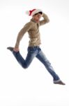 Male Wearing Santa Hat And Jumping Stock Photo