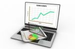 Laptop Showing A Spreadsheet And A Paper With Statistic Charts Stock Photo