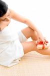 High Angle View Of Woman Scrubbing Her Legs On White Background Stock Photo