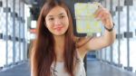 Portrait Of Thai Adult Beautiful Girl Using Her Smart Phone Selfie Stock Photo