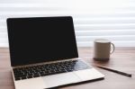 Laptop With Blank Screen On Table Stock Photo