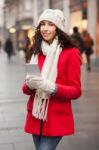 Woman In Red Coat And Wool Cap And Gloves With Smartphone In Han Stock Photo