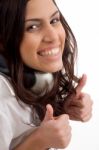 Caucasian Female Wearing Headphones And Gesturing Thumbs Up Stock Photo