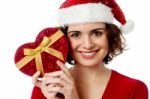 Female Santa Holding Xmas Gift Stock Photo