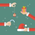 Santa Claus Hand Holding Christmas Objects Stock Photo