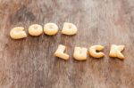 Good Luck Alphabet Biscuit On Wooden Table Stock Photo