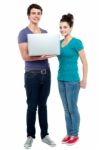 Young Couples Holding Laptop Stock Photo