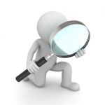 Figure Holding Magnifying Glass Stock Photo