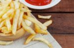 French Fries And Sauce On Wooden Stock Photo