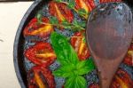 Baked Cherry Tomatoes With Basil And Thyme Stock Photo