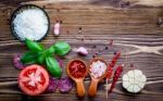 The Ingredients For Homemade Pizza On Shabby Wooden Background Stock Photo