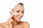 Beautiful Female Applying Moisturizer Stock Photo