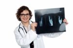 Female Surgeon Holding Up X-ray Sheet Stock Photo