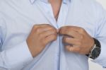 Businessman Buttoning Shirt Stock Photo