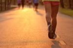 Feet Of Runner In Evening Light Stock Photo