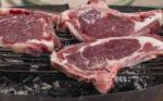 Grilling Steak On The Barbecue Stock Photo