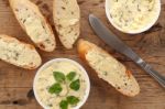 Baguette With Herb Butter And Rosemary Thyme On Rustic Wooden Background Stock Photo